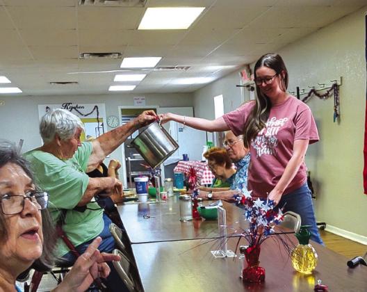 Bernice Adams is drawing a lucky winner from the bucket for the June Raffle. And yes, that is Rosa Arrendondo at the bottom left. She is pointing letting us know it was time for the drawing!