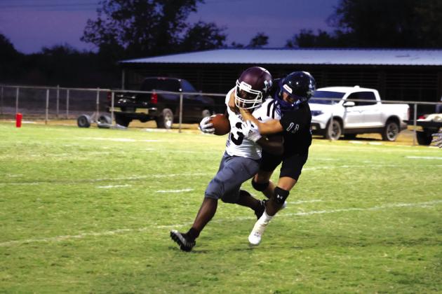 Coyote #13 Cohen Ethridge is making a tackle in last Friday night’s win over High Island Cardinals. Photo by Raegan Wright