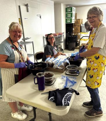 Vicki, Ginger and Helen bagging are ground beef to be frozen.