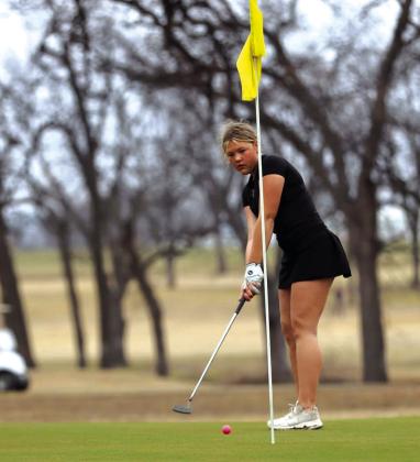 Bryli Edmondson lines things up for her putt the 1st Annual Ronnie Schulze Golf Tournament