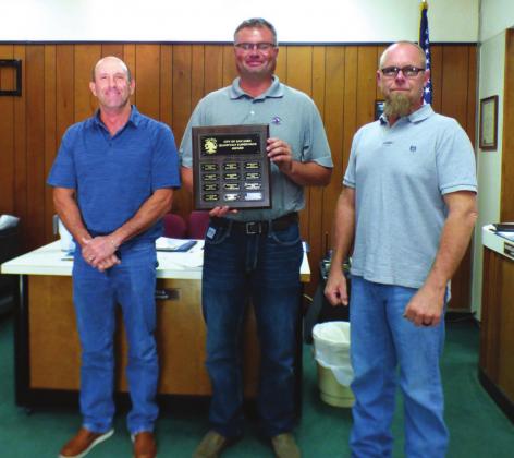 Michael Whitley, Golf Course Supervisor, displays a Supervisor of the Month plaque with his name engraved for selection as the City's Supervisor of the Month for the Third Quarter. He also received a gift certificate to a local restaurant. On Michael’s right is Scott Glaze, City Public Works Director, and to his left is Michael Nelson, Alderman.