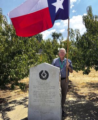 O. Scott Dunbar, KSJ is pictured here with the Commemorative Flag at the Gonzales Cannon Burial Site. Marker Inscription: On this site September 29, 1835 the Gonzales cannon was buried from the 150 Mexican Dragoons sent to demand it. Two days later it was mounted on ox-cart wheels, loaded with chains and scrap iron, and fired at the Mexican Army, the first shot of the Revolution. This location was known as George W. Davis Peach Orchard. O. Scott Dunbar, KSJ