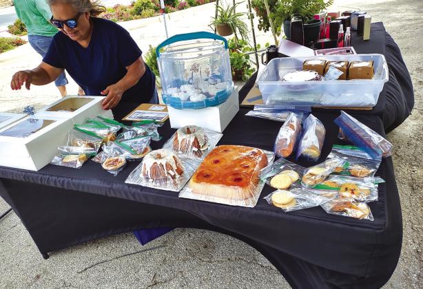 Sarah Saldivar had the booth at the corner by The Daily Mix. Her table was filled with baked goodies including cookies, cakes, cupcakes, and chocolate and coconut pies. On the other side of her table, she had a beautiful display of healthy, vibrant plants. Photo by Djuana Payton