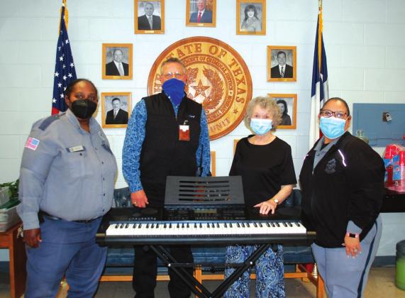 Pictured with the donated keyboard are, left to right, Major Karla Bailey, Chaplain Anderson Barlcay, Alice Smith, and Captain Sandra Anara.