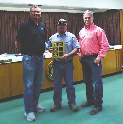 Billy Sutton, Golf Course employee, displays an Employee of the Month plaque with his name engraved for selection as the City's Employee of the Month for June. He also received a gift certificate to a local restaurant. At Billy's right is Michael Whitley, Golf Supervisor, and to his left is Marcus Amthor, Alderman, taking part in the formal presentation.