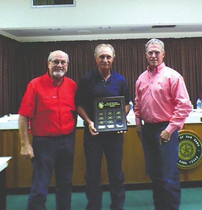 Bruce Stewart, Maintenance Supervisor, displays a Supervisor of the Quarter plaque with his name engraved for selection as the City's Supervisor of the 2nd Quarter (June). He also received a gift certificate to a local restaurant. At Bruce's right is Stan Weik, City Manager, and to his left is Marcus Amthor, Alderman, taking part in the formal presentation.