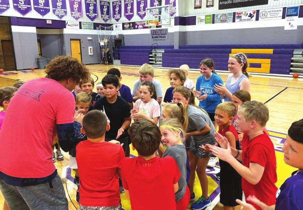 Campers from the younger group gather around Austin Johnson (left) on Wednesday, June 29, during the Austin Johnson's Academy of Hoops Elite Skills Basketball Camp held at Armadillo Arena in San Saba. (Photo courtesy of Austin Johnson's Academy of Hoops)