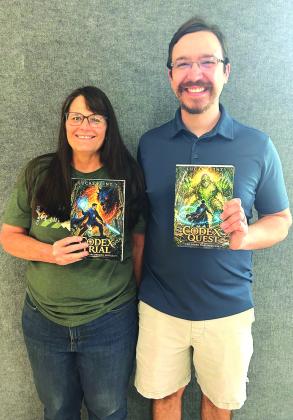 Lucas Flint is shown here with Kandis Dobbs, our librarian, and she is holding Lucas' newest books, Codex Quest and Codex Trial.