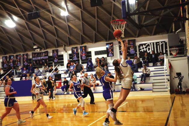 #1 Paige Bailey is reaching for the basket in last week’s game against Cherokee, and #2 Emma Bryant is also seen in the background Courtesy of Pam Starr