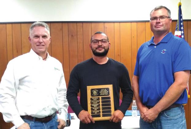 Jesse Gonzalez, Golf Course Employee, is displaying an Employee of the Month plaque with his name engraved for selection as the City's Employee of the Month for May. He also received a gift certificate to a local restaurant. On John's right is Alderman Marcus Amthor, and on his left is Michael Whitley, Golf Course Supervisor. (Staff Photo)
