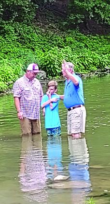 Last Sunday night, Riley Falkner was baptized in the San Saba River by his grandfather, Bill Falkner (on the right), with his father, Gavin Falkner (on the left), by his side. Many members of the church were also there to support Riley and celebrate his new life in Christ. ––Staff Photo