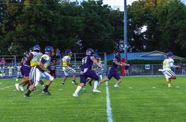 Defensive lineman #10 Jack Stewardson and #51 Kaylub Roberts rush Pathway Academy QB for yards lost.