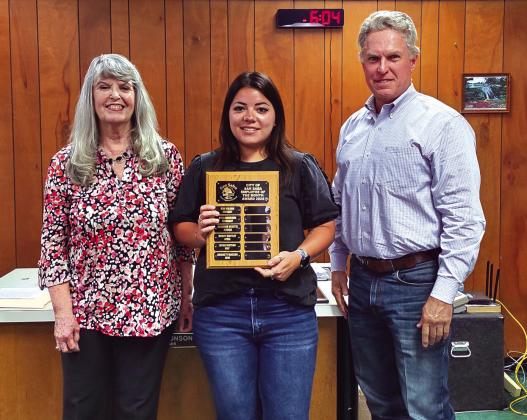 Bridget Macedo, Utility Billing Coordinator, was named Employee of the Month for June 2024. Her supervisor, City Treasurer Charlene Lindsay, and Alderman Marcus Amthor took part in the presentation. Bridget is seen here holding a dedicated plaque with her name on it. She was also presented with a gift certificate to a local restaurant.