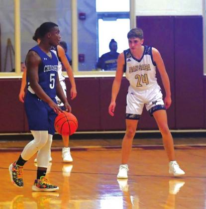 San Saba High School boys varsity basketball guard Drake Bryant (24) plays defense on Friday, December 3rd, during the Dillos’ 53-23 victory over Cherokee High School. (Photo by Rita Boultinghouse)