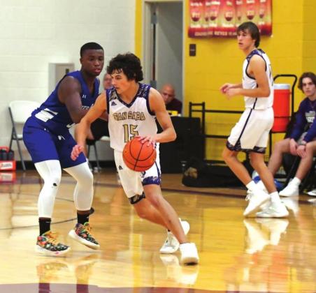 San Saba High School boys varsity basketball guard Reagan Mejia (15) dribbles the ball around a defender on Friday, December 3rd, during the Dillos’ 53-23 victory over Cherokee High School. (Photo by Rita Boultinghouse)