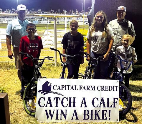 Capital Farm Credit Calf Scramble Winners-Saturday night Marcus Amthor presenting bicycles to: Lily Manning, Paisley Dubose, Scarlet Smithson, and Kyler Bessent