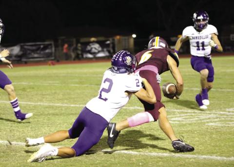 Sterling Proffitt holds on for a tackle against the Bulldogs in last Friday’s game. Courtesy of Kayti Lackey - 1916 Athletics