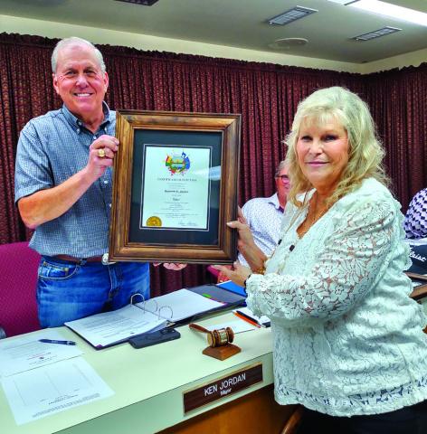Judge Sharon Blossman presents the Certificate of Election to Mayor Ken Jordan after the swearing in ceremony.
