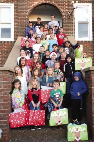 Wednesday Church Kids gathered on the steps of First Baptist with the gifts that were donated by Brother Mack's Army Reserve group. Photo by Pam Starr