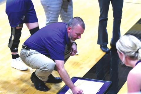 San Saba High School girls varsity basketball first-year head coach Chris Jost huddles around his team and draws up a play during a Lady Dillos' game in the historic 2021-22 season for San Saba. (Photo courtesy of San Saba All-Sports Booster Club)