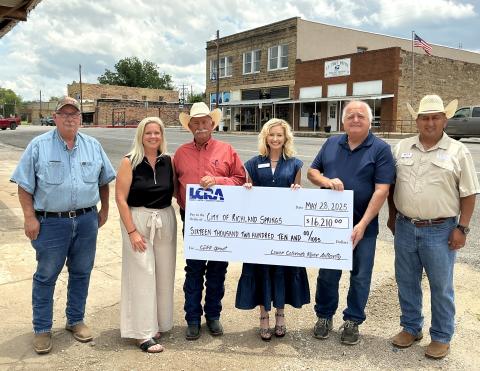 LCRA representatives present a $16,210 grant to the City of Richland Springs for dining space and restrooms at a community food-truck park planned for downtown. The grant is part of LCRA’s Community Development Partnership Program. Pictured, from left to right, are: Mike Poe, San Saba County Precinct 2 Commissioner; Paige Moats, community volunteer; Frank Pearce, mayor; Margaret D. “Meg” Voelter, LCRA Board member; Chris Perry, city manager; and John Palacio, LCRA Regional Affairs representative.