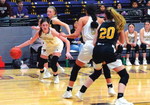 San Saba High School girls varsity basketball senior forward Landri Glover (21) drives to the basket on Tuesday, December 14, during the Lady Dillos’ 48-27 home victory vs. rival Goldthwaite High School. (Photo by Rita Boultinghouse)