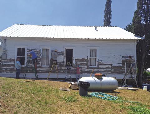 Eric Swartzell, Doug Messer, Anthony Henniger, Jennifer Swartzell, and Brandie Henniger are hard at work on the Bend Church of Christ building getting it ready to paint! Courtesy of Brandie from the Bend