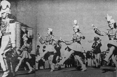 SAN SABA MAJORETTES IN ACTION––The Drum Major and Majorettes of San Saba's Armadillo Band are shown marching in the lead of the band down Commerce Street in Brady at the Heart o' Texas Band Festival on Saturday, March 6. Gordon Clark (extreme left) is drum major; and the majorettes, left to right, are Barbara Shaw, Martha Terry, Jo Garrett adn Bobbie Locker.