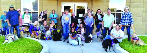 Group of participants of the Purple Paw Parade in San Saba.