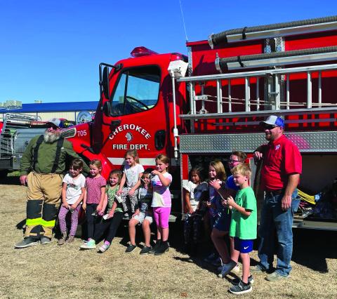 Chief Brooks and VFD volunteer Ryan Duggan pose with students. Cherokee VFD firefighter Keith Davis (not pictured) assisted.