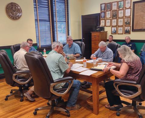 Commissioners Court going over Minutes of previous Court meetings. (l-r) Greg McGregor (Commissioner Pct. 4) Judge Jody Fauley, Kenley Kroll (Commissioners Pct. 3), Mike Poe (Commissioner Pct. 2, James Lebow (Commissioner Pct. 1), Kim Wells, (County/District Clerk). Sitting behind them is Chief Deputy Reid Daly and Sheriff David Jenkins.