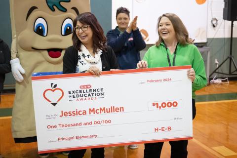 Jessica McMullen (right), principal of R.J. Richey Elementary, Burnet CISD, was a finalist in the 2024 H-E-B Excellence in Education Awards. Representatives from H-E-B surprised her with a $1,000 check.