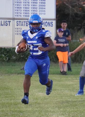 Christopher Miller carrying the ball in the game against Sidney / Courtesy of Valerie Valdez