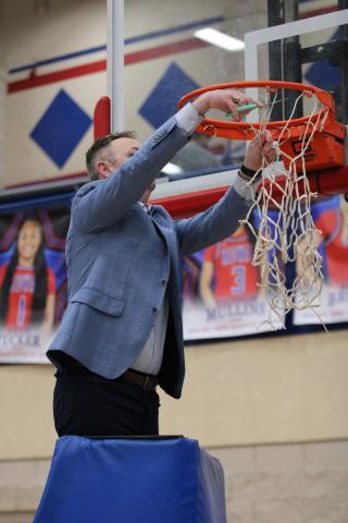 Coach Robert Gray cutting the net after San Saba's Tuesday night State Semi-Final game win against LaPoynor 