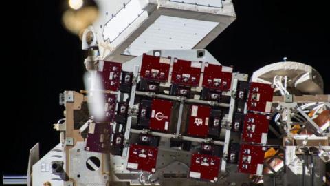 A concept graphic of the TAMU-SPIRIT attached to an EXPRESS Logistics Carrier on the exterior of the International Space Station. Individual science carriers are shown in maroon. Courtesy of Aegis Aerospace