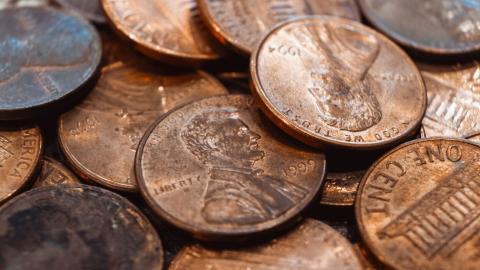 Stacks of pennies may soon become relics of the past as the U.S. Mint ends production, citing high manufacturing costs and a shift toward a cashless economy.  Credit: Getty Images