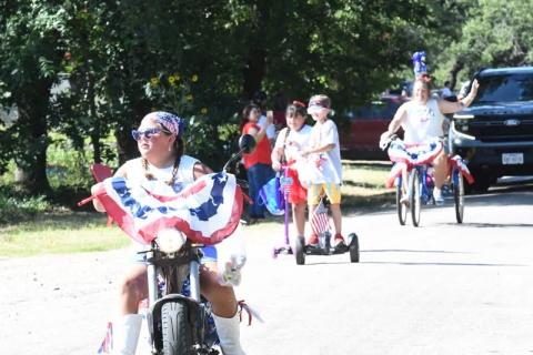 Fourth of July parade participant Phoebe Valdez is pictured here in front while Victoria Vasquez, Brantley Shannon, and Valerie Valdez follow behind. Courtesy of Rita Boultinghouse