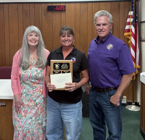 Zane Churchill (center), Accounts Payable Clerk for the City, was chosen as the Employee of the Month for August of 2026. Taking part in the presentation were City Treasurer Charlene Lindsay (left) and Alderman Marcus Amthor (right).