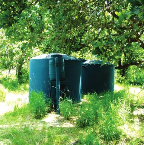 “Even sizable water tanks (2500 gallons each) can fit under trees or behind shrubs.”