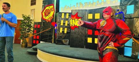Pictured here is the new Preacher at Second and Wallace Church of Christ, Justin Bell, teaching the kids at Super Heroes of the Bible VBS this week. Helping Mr. Bell on the stage tell the kids about Jesus is FLASH (Kyla Hibler). They had a great time! Photo courtesy of Second and Wallace Church of Christ