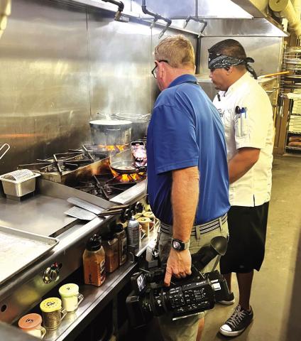 Jose Vazquez demonstrating the preparation of one of his delicious dishes for 'Brad the News Guy' from KWTX News. / Courtesy of Ashley Vazquez
