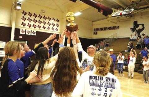 Mr. Womack presenting the Bi-District trophy to the RS Girls Volleyball Champs