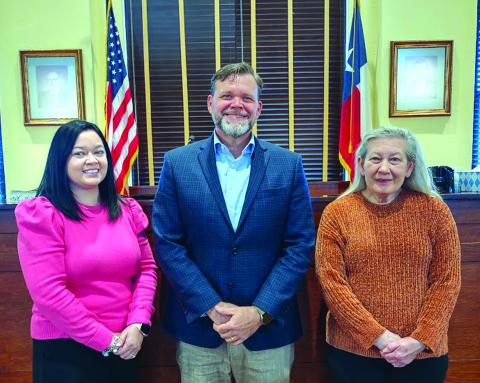 After 41 years of faithful service to San Saba County, County Clerk Kim Wells handed the mantle over to Deputy Clerk Christy Whitley (left) who was sworn in by Judge Jody Fauley (center) during the Commissioners Court meeting on January 6, 2025. Photo by Djuana Payton