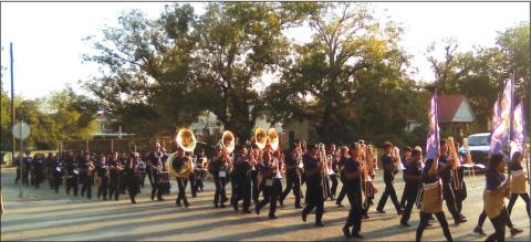 San Saba Golden Armadillo Band is being escorted by Sgt. Charlie Boyce of the San Saba Police Department to the graveyard for the game last Friday night. Courtesy of Carolyn Preece