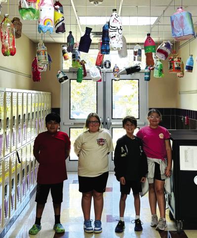 Pictured here are Classroom Ambassadors (l-r): Kevin Castillo Ramirez, LeighAnn Disotell, Hugh Henslee, and Raegan Hay and a portion of the artwork in their completed project. Courtesy of Terri Ellis