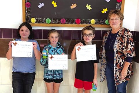 Poetry Contest 3rd Grade SSES: (l-r) Ava Spence-2nd place, Finley Wright-3rd place, Corbin Ward-1st place, Debbie Shahan-award presenter