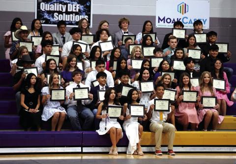 Eighth Graders posing with their diplomas at their graduation to high school. | Photo courtesy of Kayti Lackey/1916Athletics