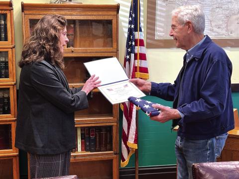 Carol Cunningham presents Judge Byron Theodosis with a certificate in honor of his 20 years of service as County Judge. Photo Courtesy of Carol Cunningham