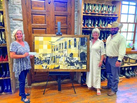 Texas Farm Bureau Insurance Agents, Shelia Meador and John Hert, placed the winning bid in the San Saba High School Mural Auction. This Mural was created by 80+ SSHS Art Students during the 2022-2023 year as a project for Big Art Day. A special thanks to Harry’s Boots for displaying the mural. Pictured are Shara Wright, Shelia Meador and John Hert. Photo by Rebekah Rinkenberger
