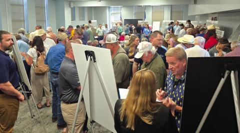 The Salado ISD Administration Building was packed with people during an open house on Monday evening regarding a proposed transmission line that would slice through a slew of Hill Country counties. The Meadows Room was ringed with maps that showed the line while Oncor and LCRA representatives were on hand to answer questions from residents. Photo by Emily Hilley-Sierzchula/News